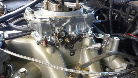 1976 Ford Ranchero - Carburetor and intake manifold assembly with visible linkages and cables.