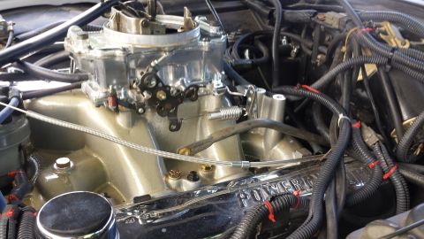 1976 Ford Ranchero - Engine bay detail showing the intake manifold and carburetor assembly with numerous wires and hoses.