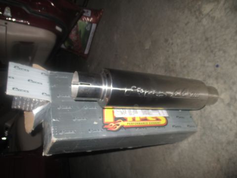 2004 Ford Crown Victoria - A new exhaust muffler, possibly for a Ford Crown Victoria, rests on its packaging. The box indicates it's from STS Performance Exhaust.