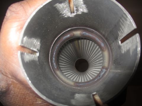 2004 Ford Crown Victoria - Inside view of a custom muffler insert, showing the perforated baffle system.