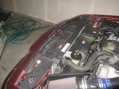 2004 Ford Crown Victoria - Close-up view of the engine bay, highlighting an aftermarket air intake system and coolant reservoir.