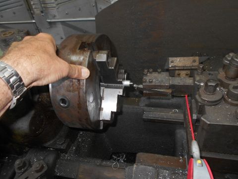 1992 Ford Bronco - Machinist operates a lathe, carefully adjusting the chuck for precision work.