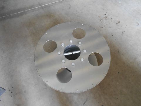 1992 Ford Bronco - This aluminum wheel, likely a custom or aftermarket part, is shown from a top-down perspective on a concrete surface.