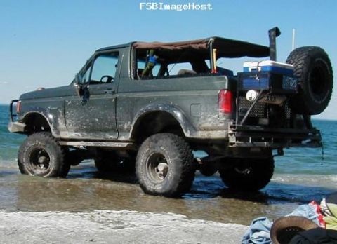 1996 Ford Bronco - This 1996 Ford Bronco is parked on the beach with the ocean in the background.
