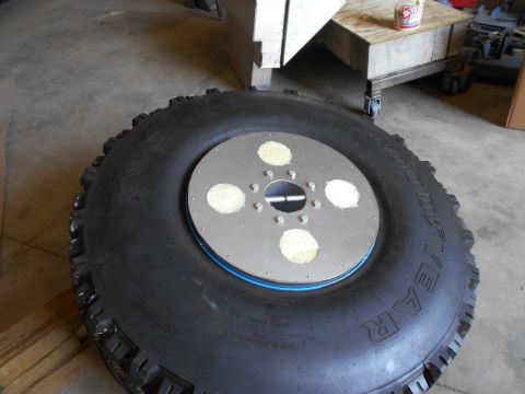 1992 Ford Bronco - This photo shows a large off-road tire and a custom hub adapter, not a 1992 Ford Bronco.