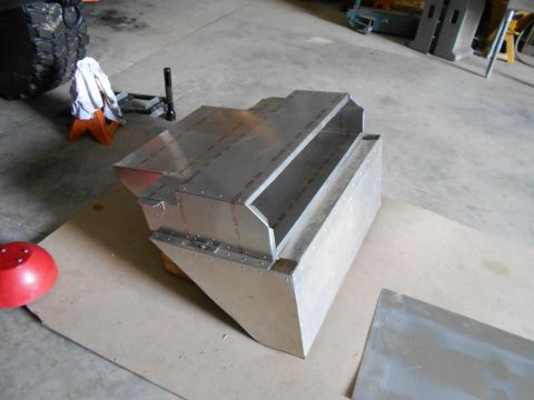 1992 Ford Bronco - An unfinished aluminum component is shown in a garage setting, with a large tire visible in the background.