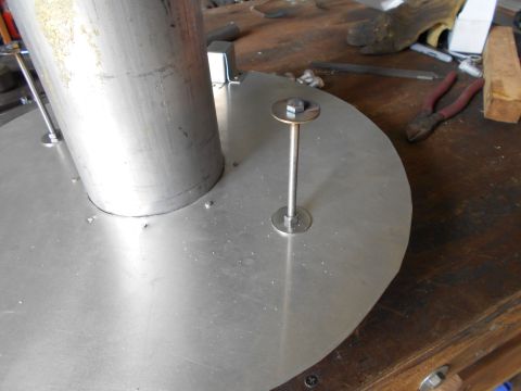 1992 Ford Bronco - A metal component with a bolt and washer is shown in a workshop setting.