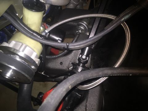 1982 Ford Bronco - A close-up view of the engine bay of a 1982 Ford Bronco, showing the power steering pump and various hoses and mechanical components.