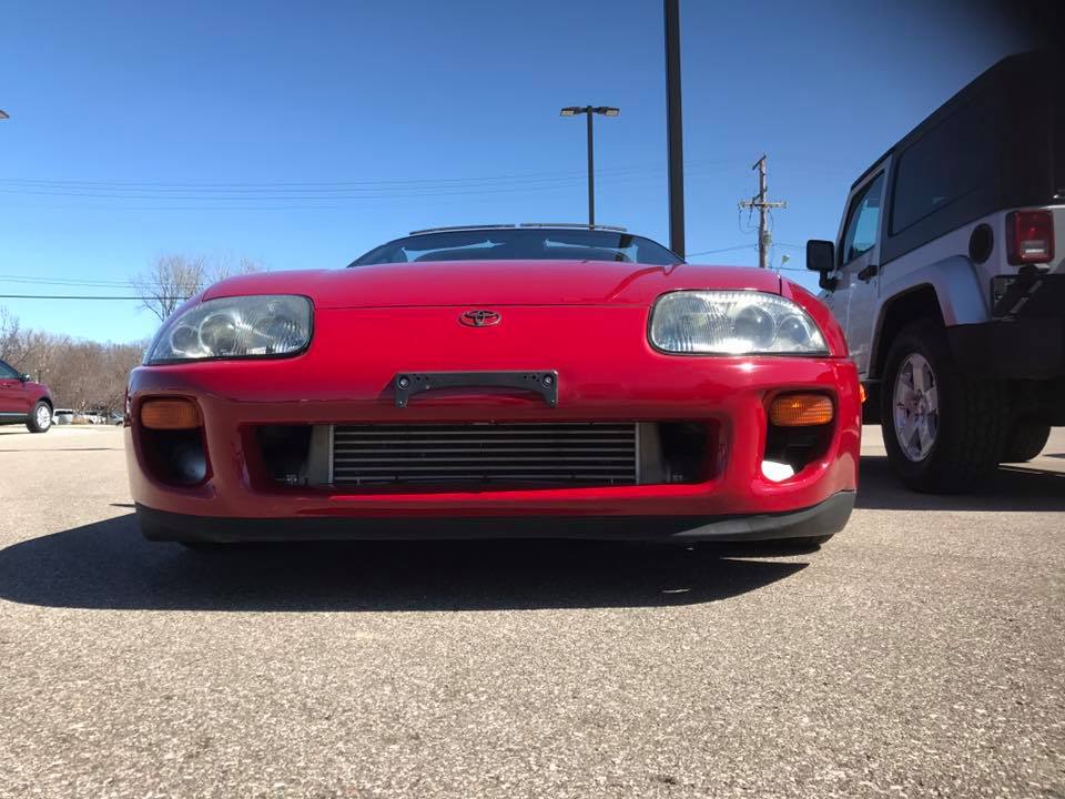 Red 1994 Toyota Supra front view with aftermarket intercooler