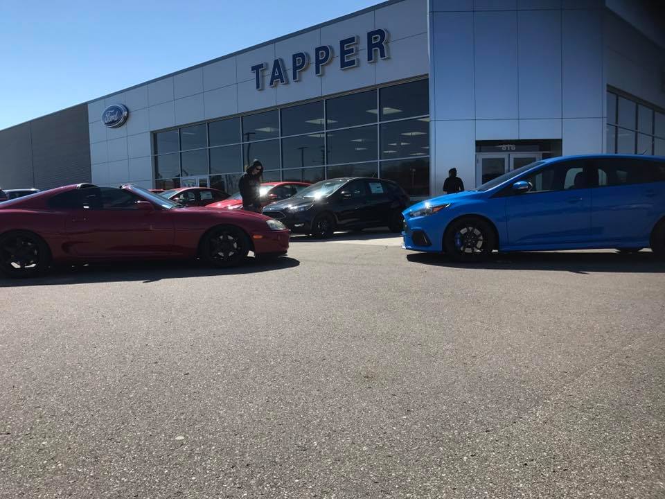Red 1994 Toyota Supra parked in front of a dealership