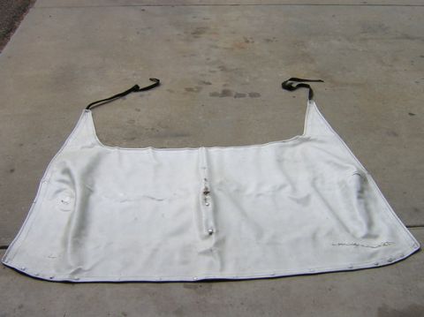 1996 Ford Bronco - A white soft top for a vehicle is shown laid out on a concrete surface.