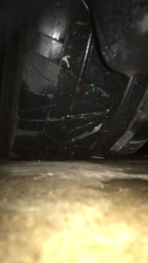 1994 Toyota Supra - A low-angle shot focuses on the tread of a vehicle's tire and the surrounding undercarriage components.
