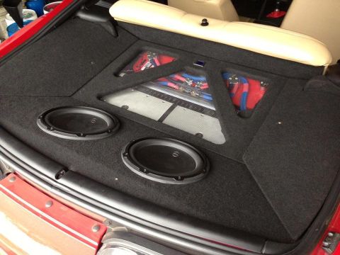 1994 Toyota Supra - Custom audio system installed in the trunk of a red car.