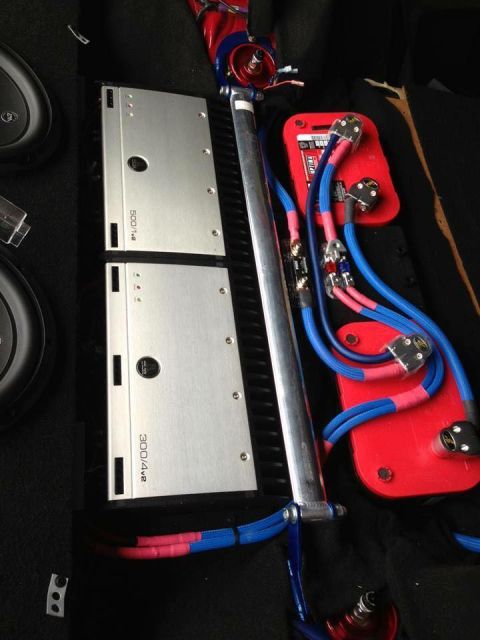 1994 Toyota Supra - Two car audio amplifiers and associated wiring are visible, along with a red power distribution block.