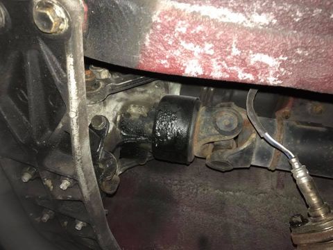 1994 Toyota Supra - Close-up view of the driveshaft and universal joint assembly on the underside of a vehicle.