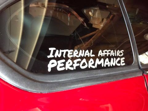 1994 Toyota Supra - A car window displays a white "INTERNAL AFFAIRS PERFORMANCE" sticker.