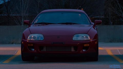1994 Toyota Supra - Front view of a red Toyota Supra with an aftermarket intercooler.