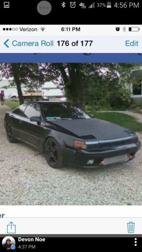 1988 Toyota Celica - This black 1988 Toyota Celica coupe is shown from the front three-quarter angle, parked on a gravel surface.