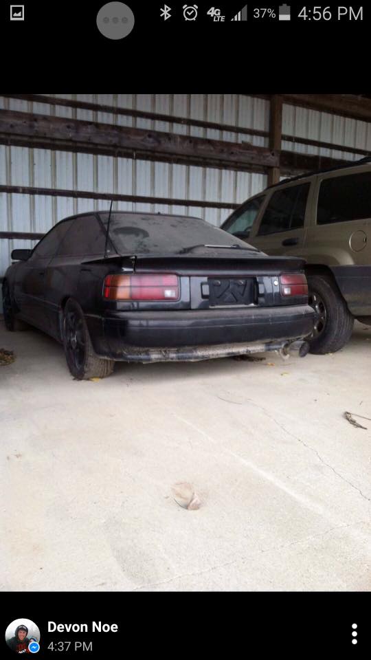 Rear view of a black 1988 Toyota Celica coupe parked indoors