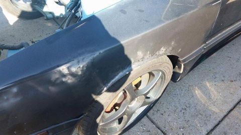 1988 Toyota Celica - The fender of a car shows signs of wear and tear, with rust visible near the wheel well.