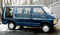 1989 Ford Crown Victoria LTD - This van is parked on a snowy surface with trees in the background.