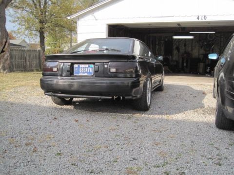 1988 Toyota Celica - Rear view of a black 1988 Toyota Celica GT-Four parked in front of a garage. Another vehicle is to the right.