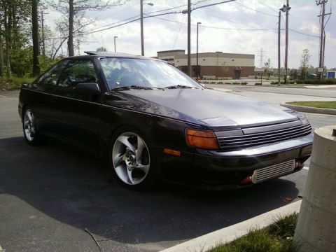 1988 Toyota Celica - This 1988 Toyota Celica coupe features pop-up headlights and custom wheels, seen from a three-quarter front angle.