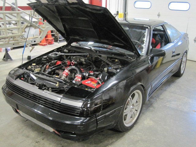 1988 Toyota Celica with hood open, showing engine bay and aftermarket modifications