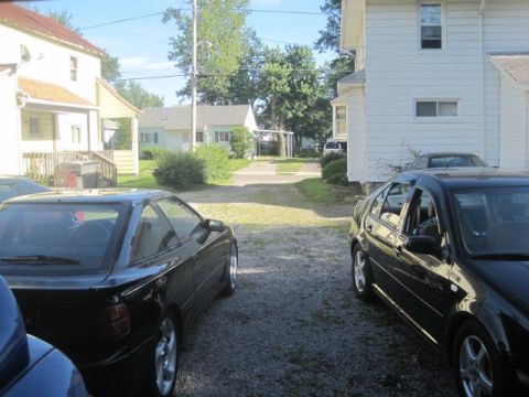 1988 Toyota Celica - Two black cars are parked in a driveway on a sunny day.