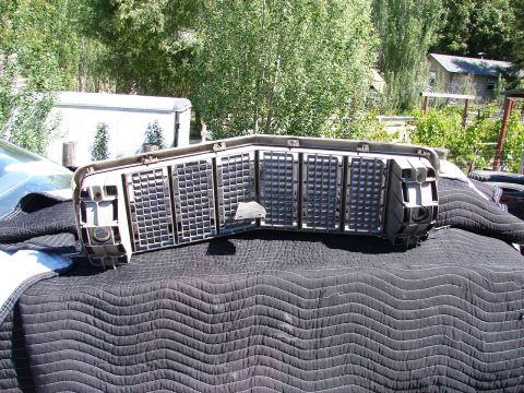 1973 Ford Ranchero - A close-up view of a vehicle's front grille assembly, resting on a protective cover.