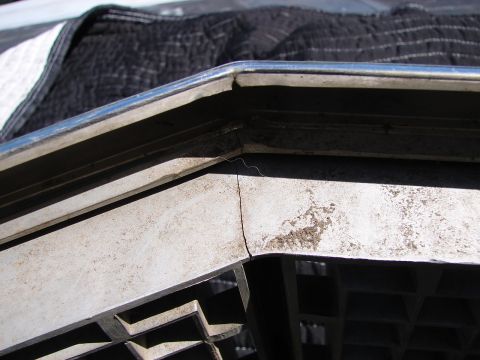 1973 Ford Ranchero - Close-up of a damaged grille and chrome trim on a 1973 Ford Ranchero.