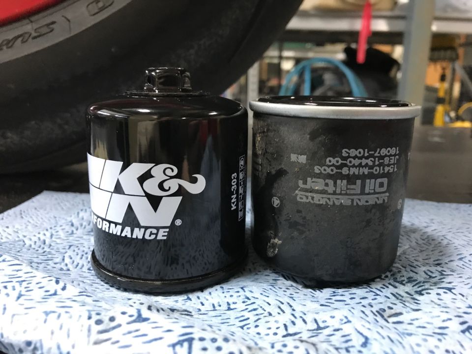 K&N oil filter next to a used oil filter