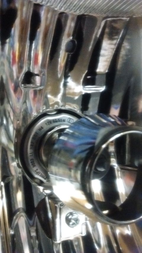 1985 Ford Bronco - The headlight assembly shows a Philips H4 bulb, indicating its lighting component.
