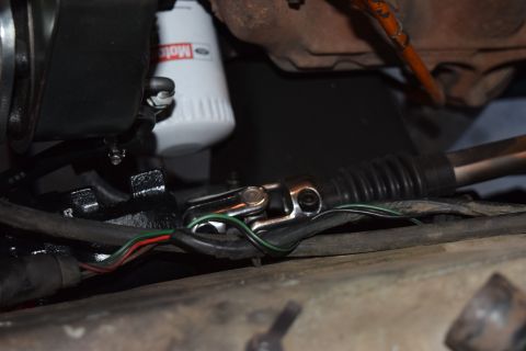 1978 Ford Bronco - Close-up view of a steering column universal joint and a Motorcraft oil filter, part of an engine bay.