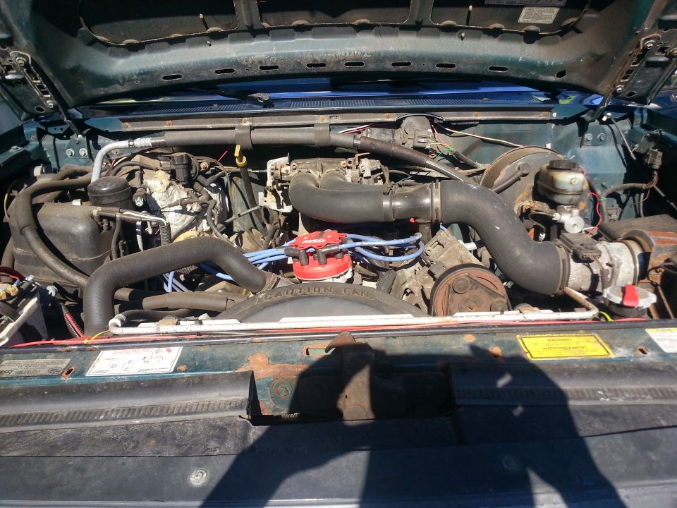 Engine bay of a 1997 Ford F-250, showing the V8 engine and associated components