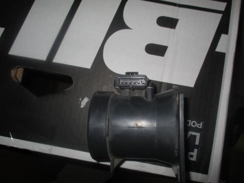 2004 Ford Crown Victoria - This is a mass air flow sensor, likely for an older vehicle. It is shown against a black background with white lettering.