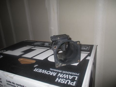 2004 Ford Crown Victoria - A black plastic mass air flow sensor is shown, likely for a vehicle part sale.