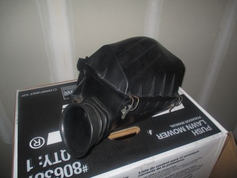 2004 Ford Crown Victoria - This is an air intake box, likely a replacement part, shown resting on a cardboard box.