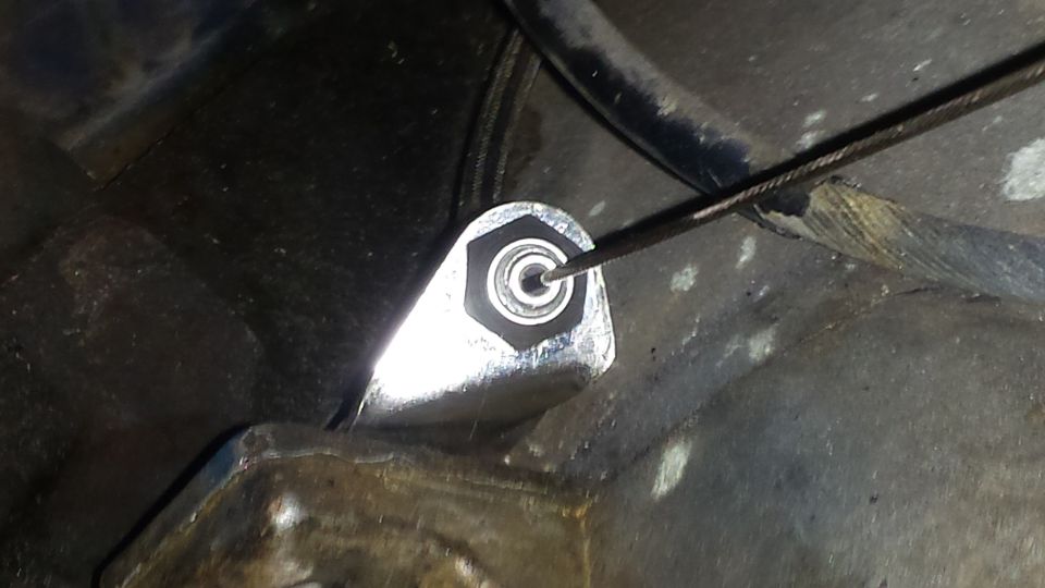 Close-up of a metal intake part with a cable being inserted