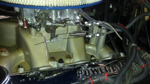 1976 Ford Ranchero - Close-up view of an engine's intake manifold and carburetor assembly, showing throttle linkage and air filter housing.