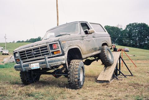 1986 Ford Bronco - This lifted 1986 Ford Bronco navigates an obstacle course, demonstrating its off-road capabilities.