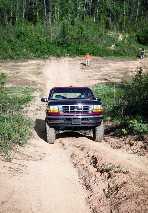 1995 Ford Bronco - 1995 Ford Bronco navigates an off-road trail.