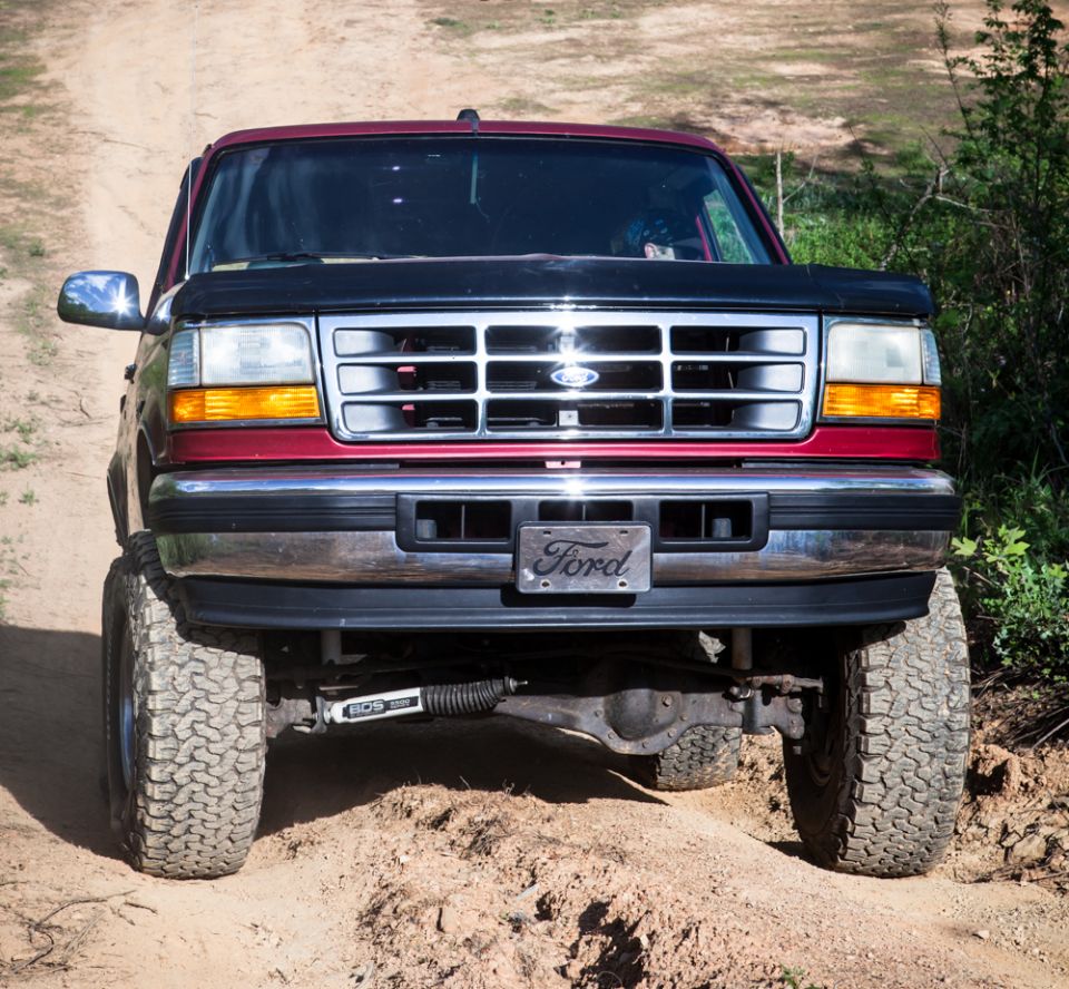 1995 Ford Bronco front view, red with black hood and grille