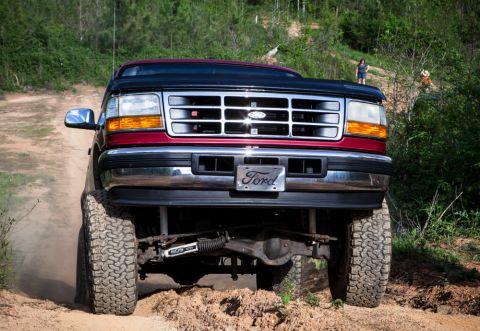 1995 Ford Bronco - This 1995 Ford Bronco is captured from the front as it navigates a dirt path.