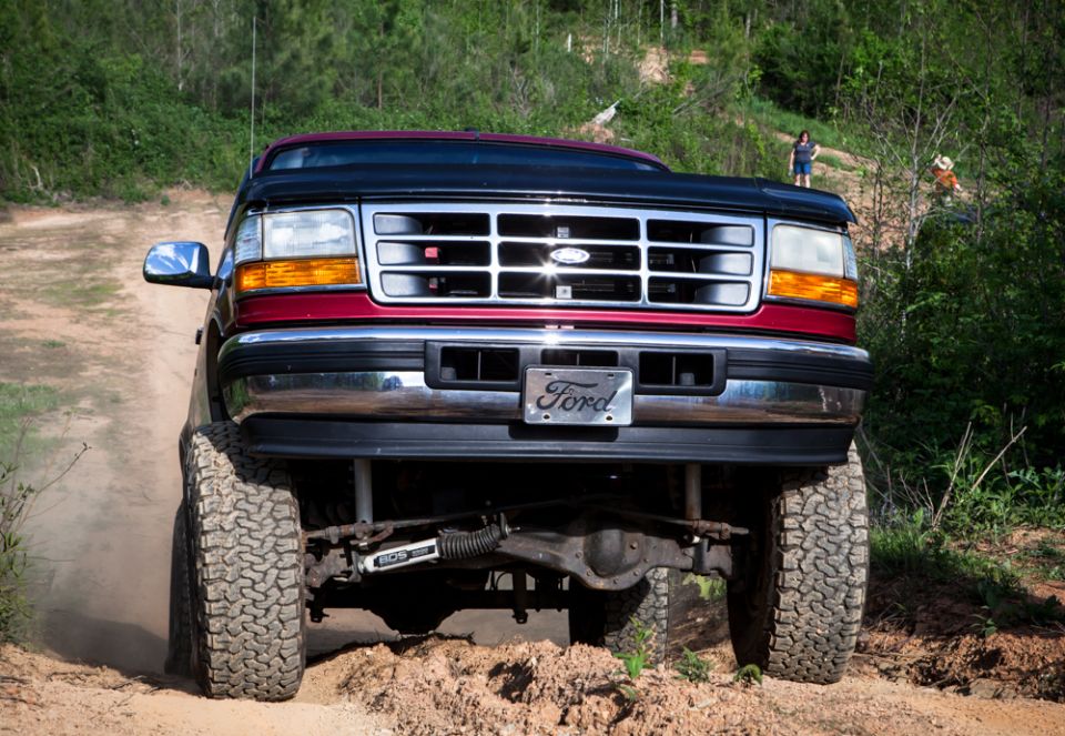 1995 Ford Bronco front view on dirt road