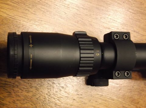 1995 Mercury Grand Marquis - A close-up view of a rifle scope, showing its magnification adjustment ring and mounting hardware.