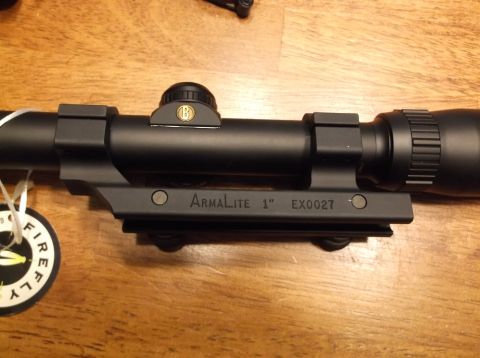 1995 Mercury Grand Marquis - A black Armalite 1" EX0027 gun scope with a Bushnell logo is shown on a wooden surface.