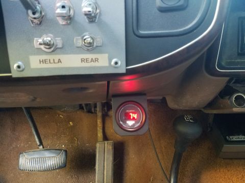 1988 Ford Bronco - Aftermarket accessories are installed in the vehicle's dashboard, including auxiliary switches and a digital gauge.