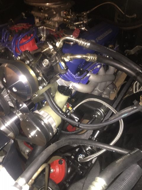 1982 Ford Bronco - Close-up view of a V8 engine bay, blue valve covers and various engine components.
