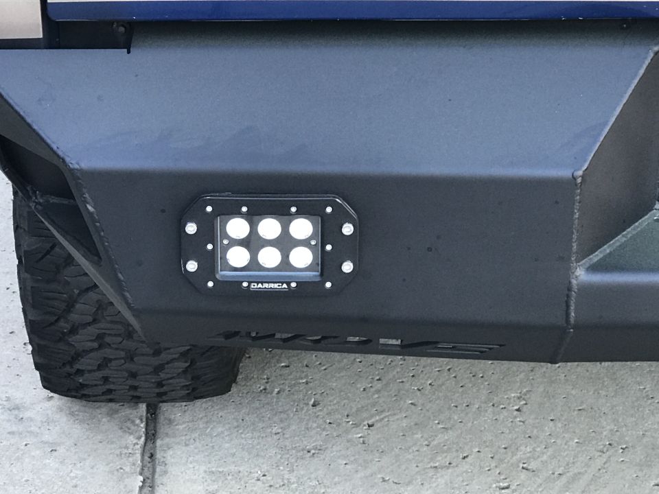 Black steel aftermarket bumper with Darriga LED light bar and vehicle tire